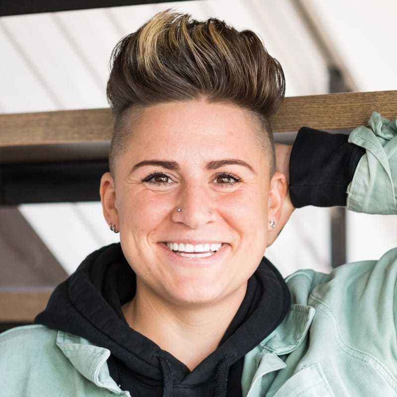 Portrait of Jess, a professional stylist at Revolutions Salon, showcasing their expertise and style.