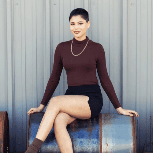 Portrait of Hailey, a professional stylist at Revolutions Salon, showcasing their expertise and style.