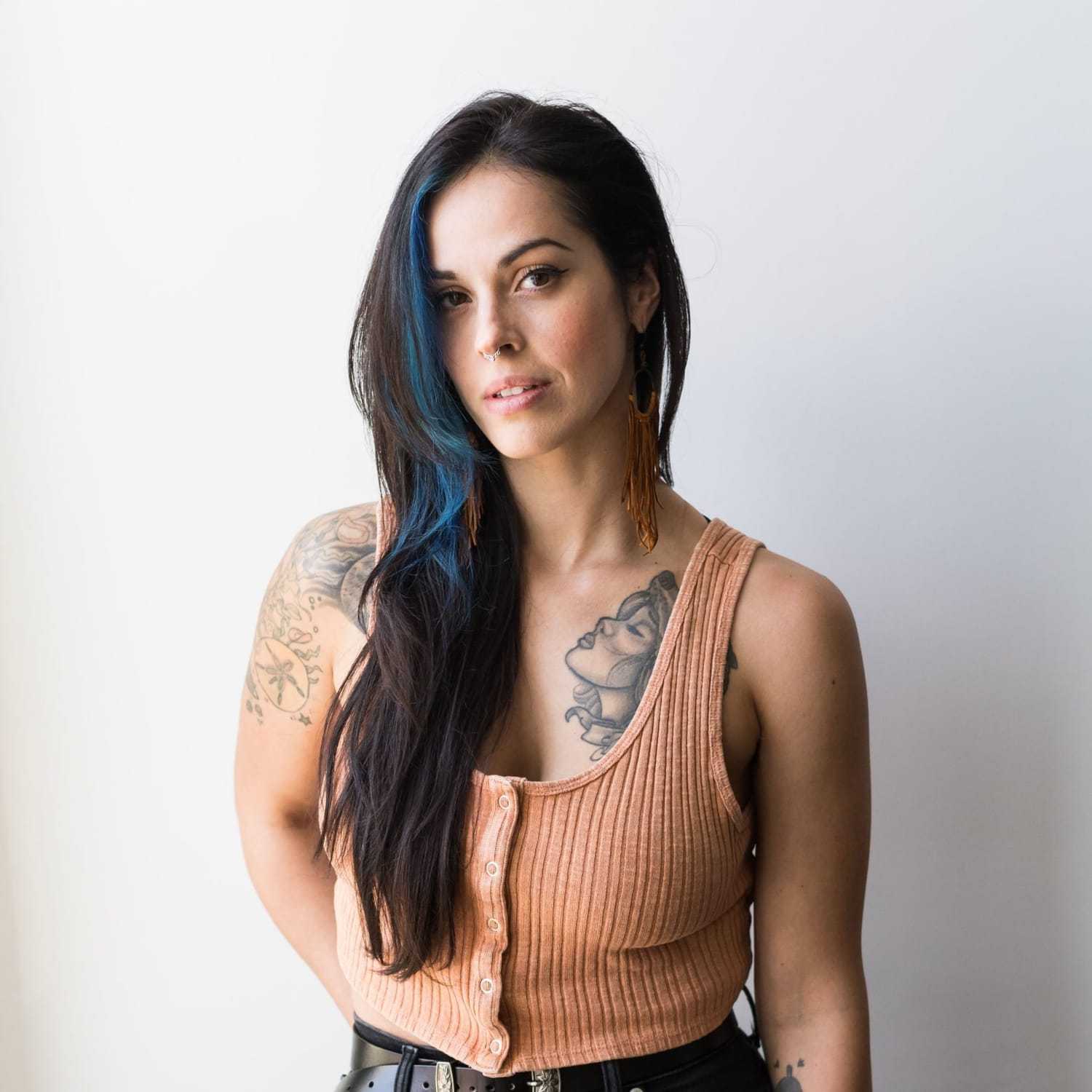 Portrait of Tamra Lee, a professional stylist at Revolutions Salon, showcasing their expertise and style.